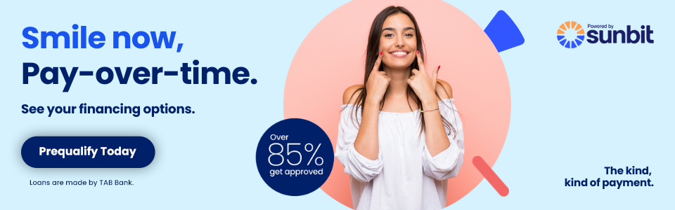 Woman smiling while holding phone, promoting Sunbit payment plans with "Smile now, Pay-over-time" message.
